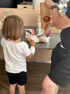 Kind verbindet einen Fuß aus Plastik